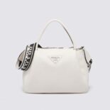 Prada Women Large Leather Handbag with the Prada Metal Lettering Logo Gleaming at Its Center-White